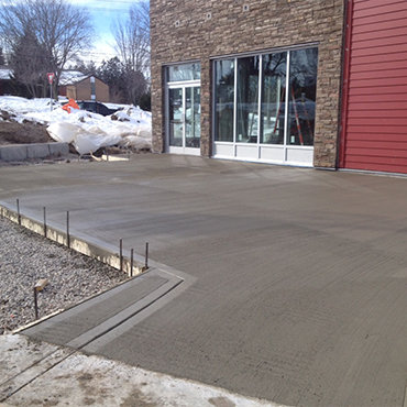 Fresh poured concrete in front of a store